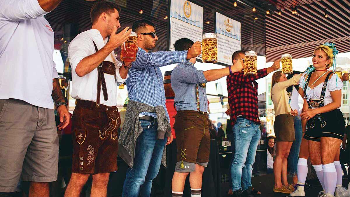 a picture of a man standing in front of a girl with a glass of beer